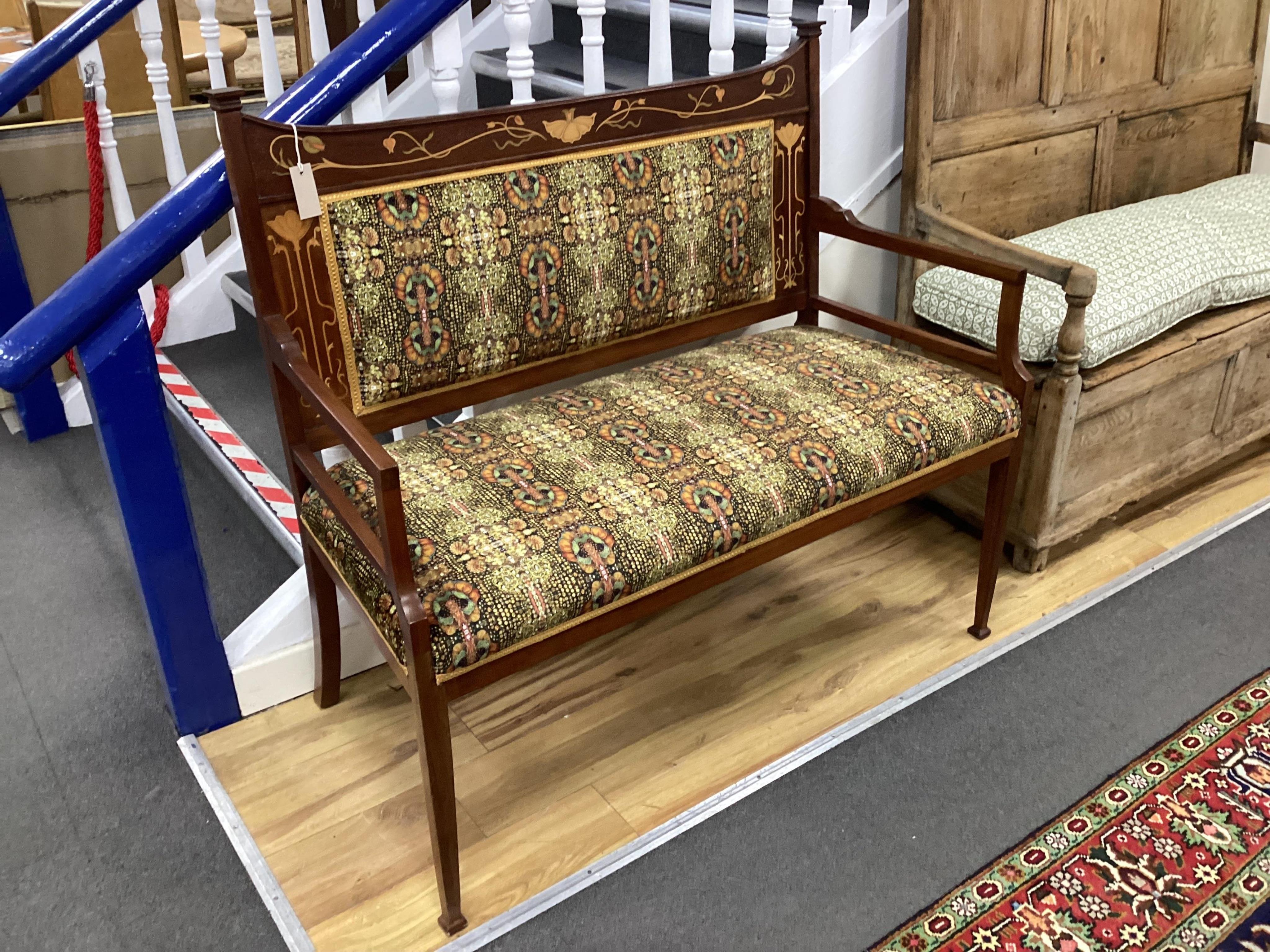 An Art Nouveau marquetry inlaid mahogany settee recently re-upholstered in Julie Kuyath fabric, width 115cm, depth 51cm, height 104cm. Condition - good